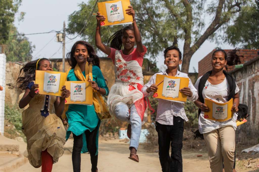 a group of kids holding up some printed material--gender equality