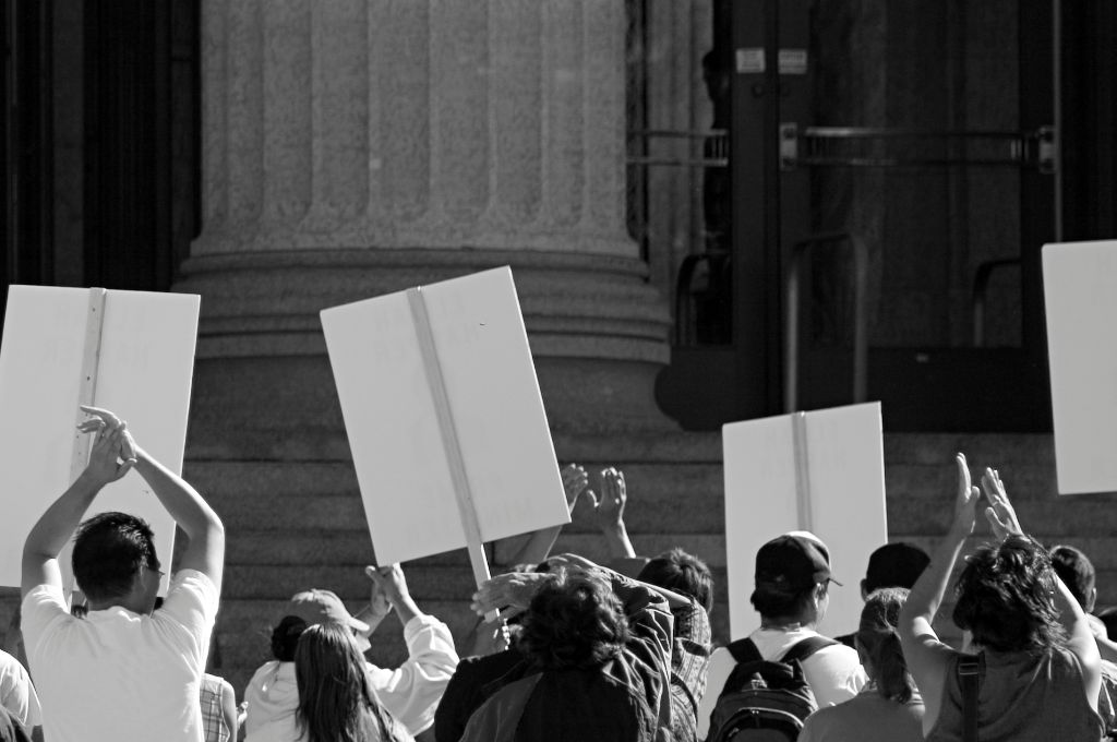 young people holding up placards at a protest--philanthropy trends