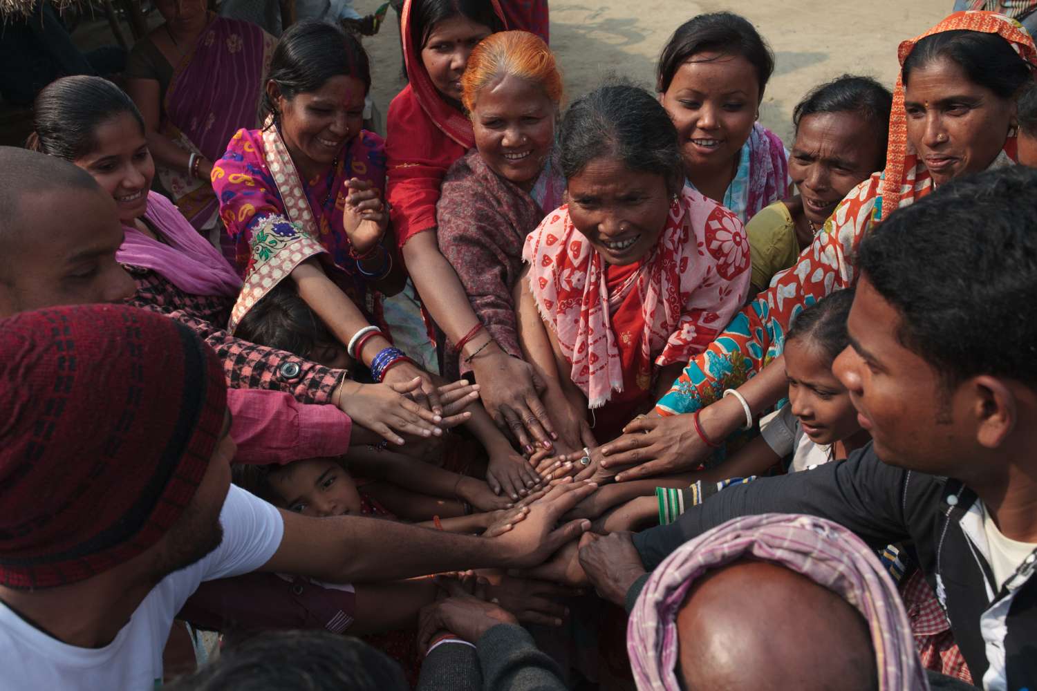 Group of people joining hands-Sara Hylton for Project Potential