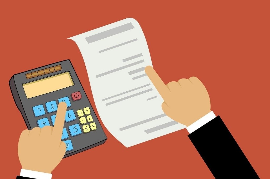 Image of a finger of the left hand on number 9 on a calculator and finger of the right hand on a while sheet_Mohamed Hassan-section 80G of income tax act